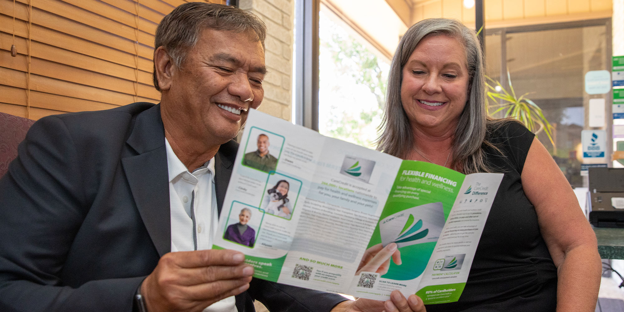 Team member and Patient Looking at Financing papers