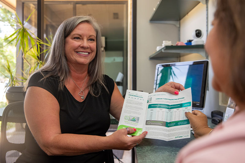 team member showing patient insurance options