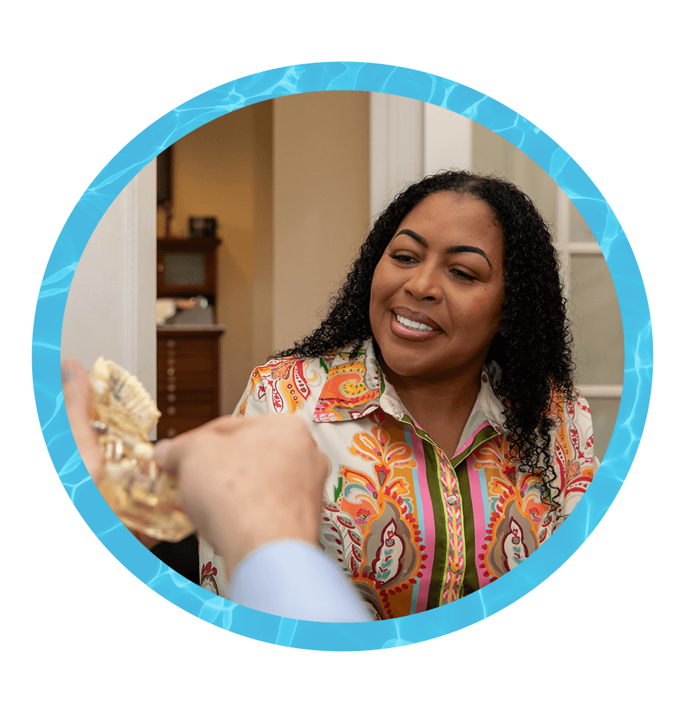 Patient looking at model of dental implants