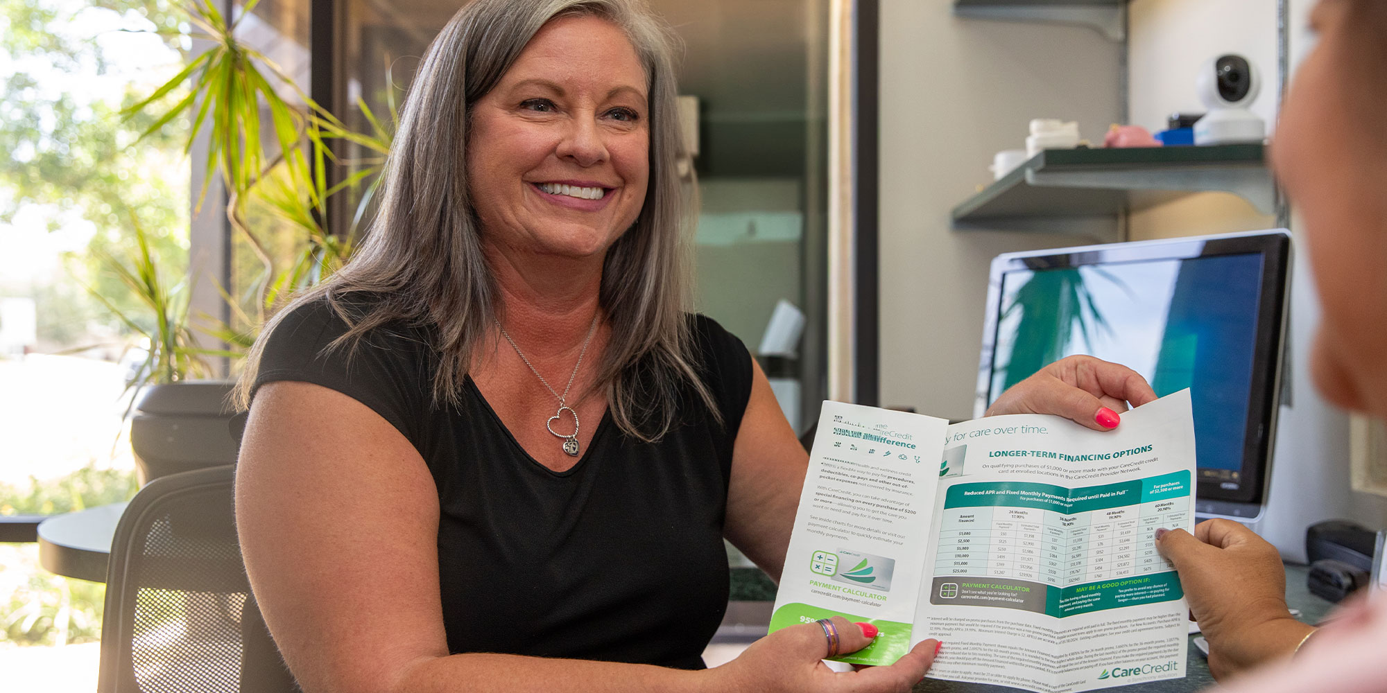 Team member holding up financing papers